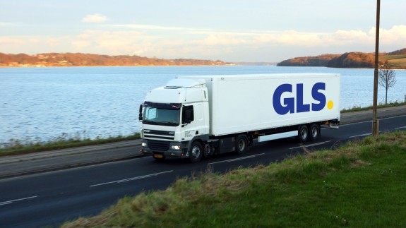 A GLS trailer drives by the water