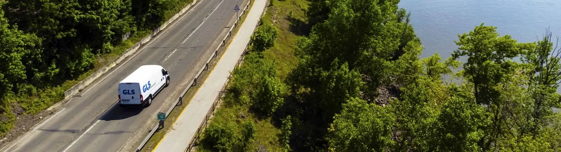 Electric delivery vehicle driving through nature