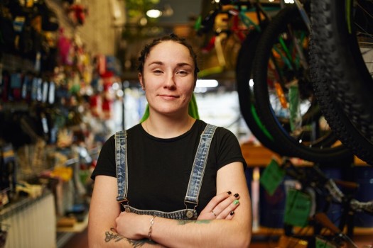 GLS business customer stands with folded arms in a store
