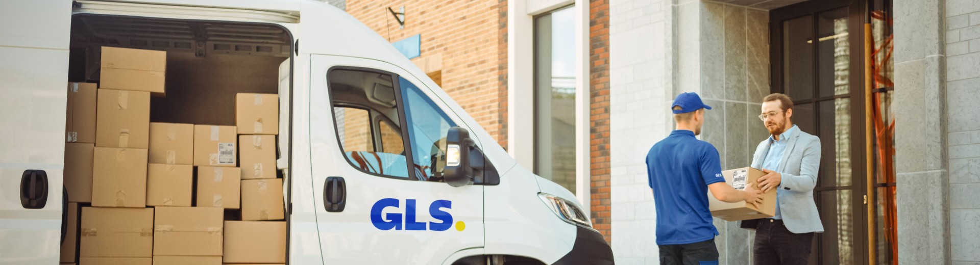 GLS driver picking up a package at a customer