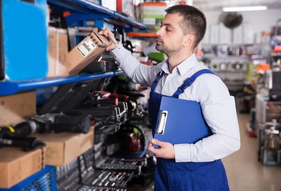 Man looking for stock on shelves in a warehouse