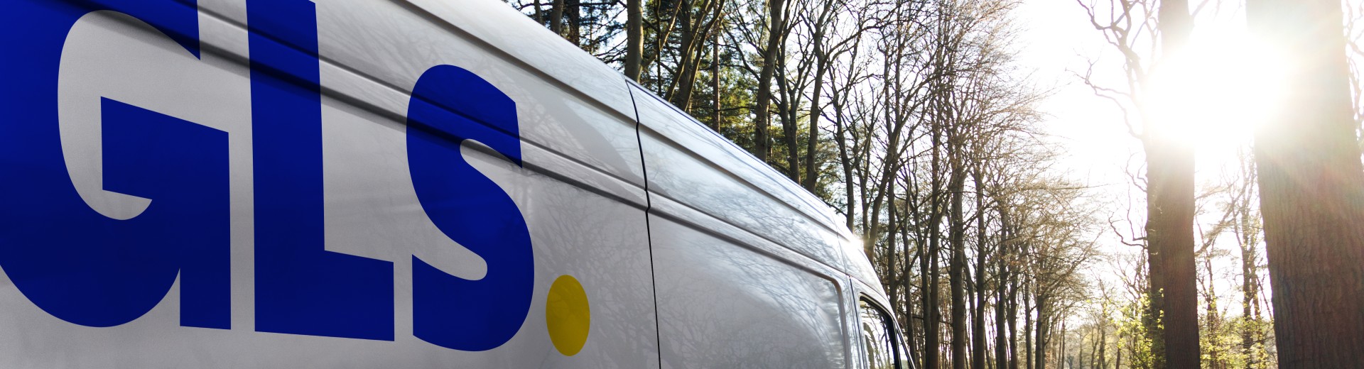 GLS delivery van driving through trees